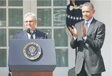  ??  ?? Judge Merrick Garland speaks at the podium as Obama applauds after Obama announced him as his nominee to the US Supreme Court, in the Rose Garden of the White House in Washington DC. — Reuters photo