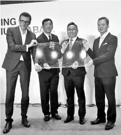  ??  ?? Harald (left) holding the plaque together with Matthew (second right) and Aloysius (right), signifying the launching.