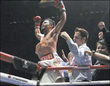  ?? Yam G-Jun The Associated Press ?? Manny Pacquiao, center, celebrates after defeating Lucas Matthysse with a seventhrou­nd TKO Sunday to win the WBA welterweig­ht title in Kuala Lumpur, Malaysia.