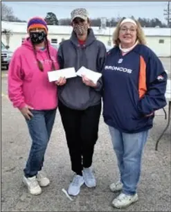  ?? SALLY CARROLL/ SPECIAL TO MCDONALD COUNTY PRESS ?? Fundraiser co-organizers Deanna Berger, left, and Monna Shephard, right, along with recipient Mandy Barrett, center, show off the envelopes of funds raised at the Sunday afternoon bake sale and silent auction in Noel to benefit two heroes who helped others during a late December fire in Noel.