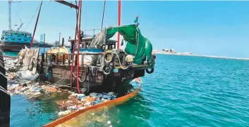  ??  ?? ■ The Dubai Police rescue team successful­ly towed the dhow to a nearby dock.