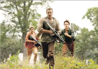  ??  ?? From left, Tris ( Shailene Woodley), Four ( Theo James) and Caleb ( Ansel Elgort) from Insurgent. The movie, which opens Friday, is based on the second novel in Veronica Roth’s Divergent trilogy.