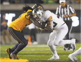  ?? Don Feria / Associated Press ?? Cal linebacker Alex Funches (left) stops Oregon running back Cyrus Habibi-Likio in the second half of a 42-24 loss at Memorial Stadium on Sept. 29, the first of the Bears’ three defeats.