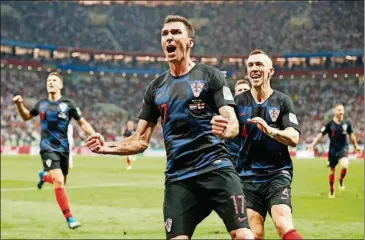  ?? FRANK AUGSTEIN/THE ASSOCIATED PRESS ?? Croatia’s Mario Mandzukic celebrates after scoring his side’s second goal during the semifinal match against England at the World Cup in the Luzhniki Stadium on Wednesday in Moscow.