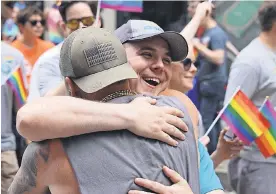  ?? PAMELA LUU ?? Scott Dittman spreads the love at the Pittsburgh Pride Parade.