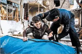  ?? MARCUS YAM/LOS ANGELES TIMES ?? A man grieves for loved ones found dead Friday in the rubble of a destroyed home after there were reported coalition airstrikes in Mosul. The U.S. military is investigat­ing.