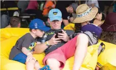  ??  ?? Stephen Whatley and his son, Jack, from Rogers, Arkansas, at the Pokemon Go Fest.