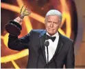  ?? ALBERTO E. RODRIGUEZ/GETTY IMAGES ?? “Jeopardy!” host Alex Trebek, shown with his Daytime Emmy Award in 2019, died Sunday at age 80.
