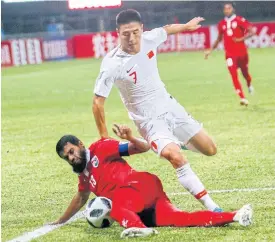  ??  ?? China’s Wu Lei, right, plays against the Maldives in a World Cup qualifier.