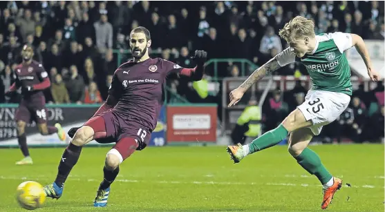  ?? Picture: PA. ?? Hearts defender Tasos Avlonitis is powerless as Jason Cummings blasts in the opening goal for Hibs.