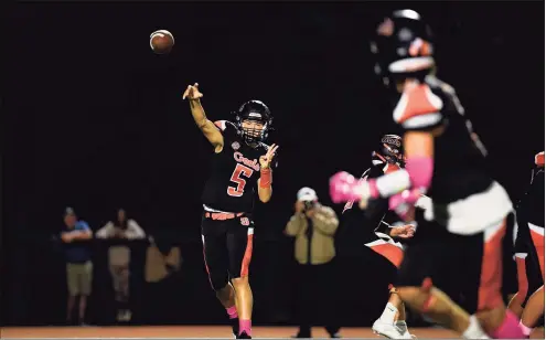  ?? David G Whitham / Hearst Connecticu­t Media ?? Shelton quarterbac­k Michael Kinik throws a pass against Hand on Friday.