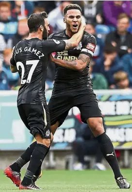  ?? AP ?? Magpies fly: Newcastle’s Jamaal Lascelles (right) celebratin­g his goal against Swansea in the English Premier League clash at the Liberty Stadium on Sunday. Newcastle won 1- 0.—