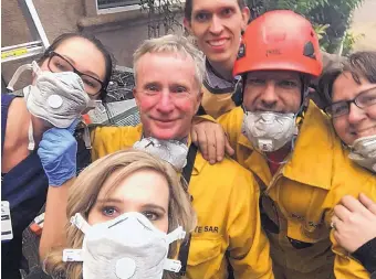  ?? COURTESY OF TAMARA FERGUSON ?? Standing in front of the garage in Paradise, Calif., that became a makeshift hospital are, from left, nurse Chardonnay Telly, firefighte­r Matt Arness, firefighte­r Joe Greco, EMT Shannon Molarius, Nurse Tamara Ferguson (front) and Dr. David Russel (rear).