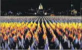  ??  ?? Nearly 200,000 flags are seen installed at the National Mall in Washington, representi­ng people who won’t be able to attend Joe Biden’s inaugurati­on due to Covid curbs and security fears.