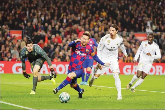  ??  ?? Barcelona’s Lionel Messi (center), vies for the ball with Real Madrid’s goalkeeper Thibaut Courtois (left), and Real Madrid’s Sergio Ramos (second right), during a Spanish La Liga soccer match between Barcelona and Real Madrid at Camp Nou stadium in Barcelona, Spain on Dec 18. Thousands of Catalan separatist­s are planning to protest around and inside Barcelona’s Camp Nou
Stadium during Wednesday’s ‘Clasico’. (AP)