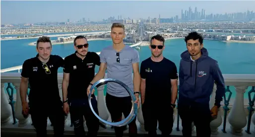  ?? Photo by Shihab ?? Elia Viviani, John Degenkolb, Marcel Kittel, Mark Cavendish and Yousif Mirza pose at the Atlantis with the Dubai skyline in the background. —