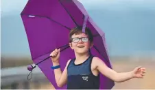 ??  ?? Noah Simpson, 7, from Kirwan, enjoys the rain at Ross River Dam on Saturday.