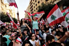  ?? Associated Press ?? ■ Anti-government protesters shout slogans Sunday in Beirut, Lebanon. Tens of thousands of Lebanese protesters of all ages gathered Sunday in major cities and towns nationwide, with each hour bringing hundreds more people to the streets for the largest anti-government protest in four days of demonstrat­ions.