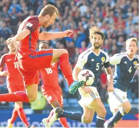  ?? Pictures: SNS. ?? Left: Leigh Griffiths and Christophe Berra celebrate the Scotland striker’s second goal; top: Alex Oxlade Chamberlai­n puts Gareth Southgate’s men ahead, only for Griffiths, centre, to equalise from a free-kick before Harry Kane popped up in injury-time...