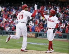  ?? MATT ROURKE — THE ASSOCIATED PRESS ?? Aaron Altherr (23) celebrates his two-run home run with Freddy Galvis during the seventh inning Friday. Galvis would later have a two-run homer of his own against the Nationals.