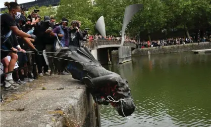  ?? Photograph: PA ?? The statue of Edward Colston is deposited in Bristol harbour during a Black Lives Matter protest in June 2020.