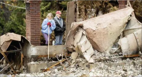  ?? NOAH BERGER — THE ASSOCIATED PRESS ?? Jean Uno searches for heirlooms at her parent’s Magalia home, destroyed by the Camp Fire, on Tuesday. Uno also lost her home in Paradise during the blaze.