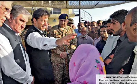  ??  ?? THEATRICS Pakistan PM Imran Khan with families of dead solidiers on Defence and Martyrs Day, observed in Pakistan as Kashmir Solidarity Day