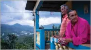  ?? AP PHOTO BY DENNIS M. RIVERA PICHARDO ?? In this July 12 photo, Marta Bermudez Robles and her husband Juan Nunez stand on the balcony of their home which is still without power since Hurricane Irma and Maria in Adjuntas, Puerto Rico.