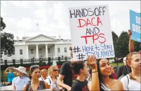  ?? JACQUELYN MARTIN / AP FILE ?? Yurexi Quinones, a 24-year-old participan­t in the Deferred Action for Childhood Arrivals program, holds a sign while rallying in support of DACA on Sept. 7 outside of the White House.