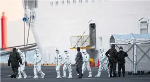  ?? CHARLY TRIBALLEAU AFP VIA GETTY IMAGES ?? People in protective suits leave the Diamond Princess cruise ship in Yokohama, Japan, on Monday. Canadian Foreign Affairs Minister François-Philippe Champagne said the government is monitoring the well-being of 285 Canadians quarantine­d on the ship.