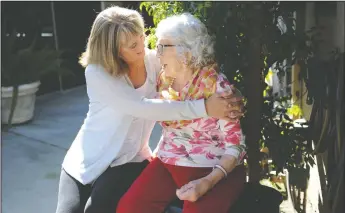  ??  ?? Above: Granddaugh­ter Melinda Mullins and Katie Logemann, 109, take pictures together during a celebratio­n of Internatio­nal Women’s Day at Vienna Nursing and Rehabilita­tion Center in Lodi on Wednesday. Below left: Photograph­er and medical records...