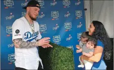  ?? MARK J. TERRILL/AP PHOTO ?? Alex Verdugo gets ready to have his picture taken with Desirae Cortez and her children Emma, second from left, and Julianna during a Dodger Stadium FanFest on Jan. 25 in Los Angeles. Verdugo was traded to the Red Sox on Tuesday night as part of a deal that sent Mookie Betts and David Price to Los Angeles.