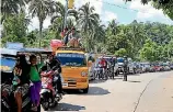  ?? PHOTOS: REUTERS ?? A government troop stands on guard checking vehicles evacuating residents from their hometown of Marawi city in southern Philippine­s.