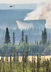  ?? CREDIT: PATRICK ENDRES / DESIGN PICS / GETTY IMAGES ?? Smoke rises from the Eagle Trail forest fire in interior Alaska, near the town of Tok.