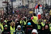  ?? AP PHOTO/THIBAULT CAMUS ?? YELLOW VEST PROTESTERS demonstrat­e peacefully in the streets of Paris, France, Saturday. Authoritie­s deployed 80,000 security forces nationwide for a ninth straight weekend of antigovern­ment protests.