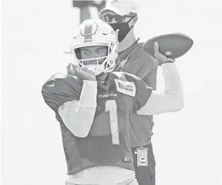  ?? JOEL AUERBACH/AP ?? Dolphins quarterbac­k Tua Tagovailoa throws the ball during a training camp practice in Davie on Tuesday.