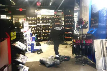  ??  ?? A policeman walks inside a vandalised GO Sport sporting goods store the day after clashes during a national day of protest by the ‘yellow vests’ movement in Paris, France. — Reuters photo