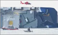  ?? Bobby Haven / Associated Press ?? A U.S. Coast Guard helicopter takes off from the side of the cargo ship Golden Ray, Sept. 9, 2019, after the vessel overturned while leaving the Port of Brunswick, Ga., early the previous morning.
