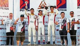  ??  ?? Good job: Mitchell Cheah (centre) raising his trophy after being crowned event champion in the Formula 4 South East Asia Championsh­ip. He is flanked by Daniel Cao of China (third from left) and Kane Shepherd from Thailand (third from right).