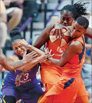  ?? SEAN D. ELLIOT/THE DAY ?? Connecticu­t Sun guard Courtney Williams, right, takes the rebound away from teammate Shekinna Stricklen and Los Angeles Sparks forward Candace Parker in the second half of a game Sunday at Mohegan Sun Arena. The Sun open the playoffs today at home with an 8:30 p.m. game against Diana Taurasi and the Phoenix Mercury.