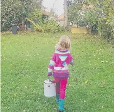  ??  ?? “I am always so impressed with how much my kids want to help,” says Katelin. One of Cléo’s jobs is to carry out the compost.