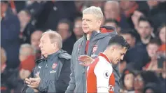  ??  ?? Arsenal’s Alexis Sanchez walks past Wenger after he was substitute­d. — Reuters photo