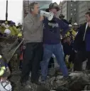  ?? GETTy IMAgES ?? IN THE ASHES: President George W. Bush speaks through a megaphone to firemen and other workers Sept. 14, 2001, at the site of the destroyed World Trade Center in New York City.