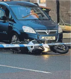  ??  ?? The victim’s motorcycle lies at the scene of the accident.