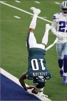  ?? MICHAEL AINSWORTH – THE ASSOCIATED PRESS ?? Rarely seen Eagles wide receiver DeSean Jackson (upside down 10) leaps into the end zone after catching an 81yard touchdown pass in the first half Sunday as Dallas cornerback Trevon Diggs looks on. It would be Jackson’s only catch as he hobbled through the rest of the game, essentiall­y summing up the season for him and his team.