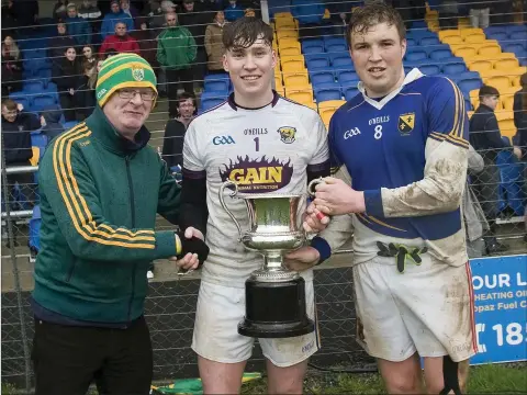  ??  ?? Coláiste Bhríde joint captains Darragh Brookes and Rory Stokes with Brian Breen.