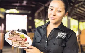  ??  ?? Melissa Murray had to pose with her favourite meal, the jerk sampler.