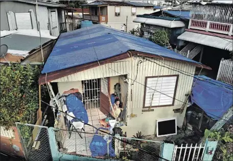  ?? Photograph­s by Carolyn Cole Los Angeles Times ?? A YEAR after Hurricane Maria, many homes in Puerto Rico still had not been repaired, including these in San Juan’s Barrio Obrero area.