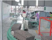  ??  ?? Workers process block rubber at a plant in the South, where workforce for higher-value rubber is much needed.