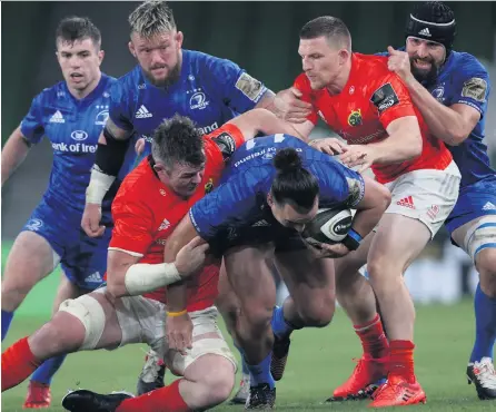  ??  ?? Rivals collide:
Leinster’s James Lowe is tackled by Munster’s Peter O’mahony and Andrew Conway